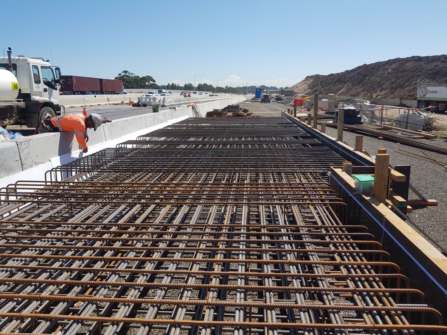 Deck reinforcement mat laid out beside the live motorway carriageway