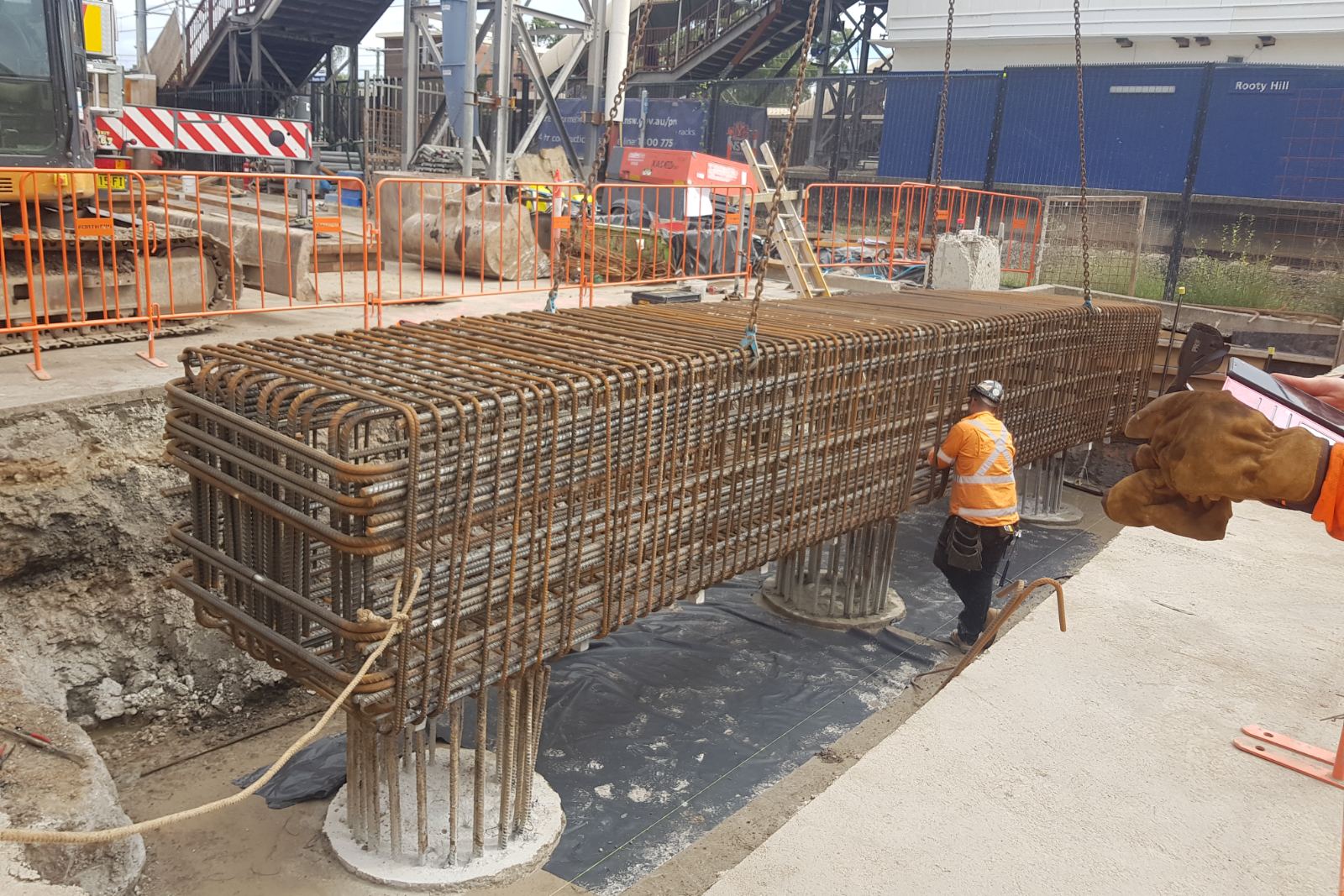 Prefabricated pilecap reinforcement cage being landed over pile starter bars